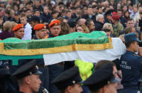 Russian Emergencies Ministry members carry a coffin during a memorial ceremony before the funeral of victims of an attack on a local college in the city of Kerch, Crimea October 19, 2018. REUTERS/Pavel Rebrov