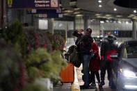 Travelers walk to a ticketing desk at the O'Hare International Airport in Chicago, Thursday, Dec. 21, 2023. It's beginning to look a lot like a hectic holiday travel season, but it might go relatively smoothly if the weather cooperates. (AP Photo/Nam Y. Huh)