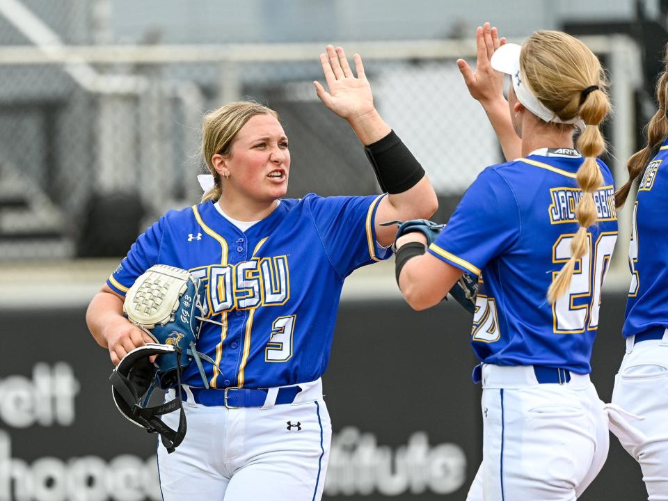 SDSU pitcher Grace Glanzer high-fives Lindsey Culver during Friday's NCAA tournament game in Orlando. The Jacks lost 2-1 to Michigan.