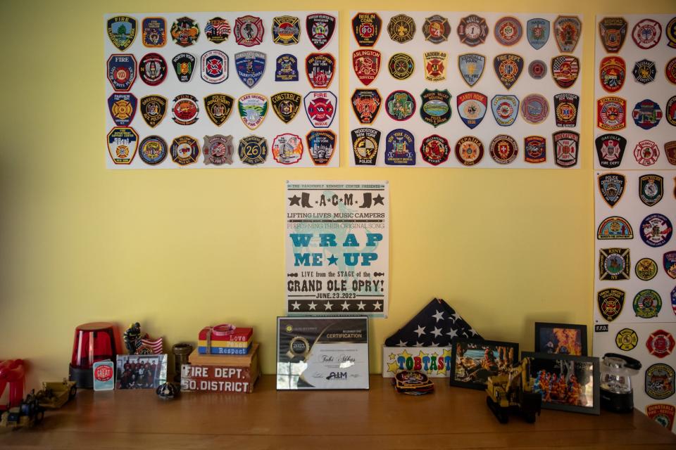 Tobi's collection of firefighter and emergency services patches that hang in his room.