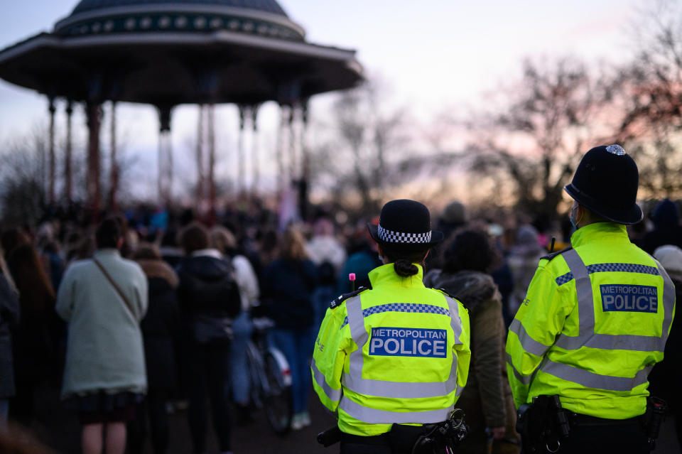 LONDON, ENGLAND - MARCH 13: People gather to lay flowers and pay their respects at a vigil on Clapham Common, where floral tributes have been placed for Sarah Everard on March 13, 2021 in London, England. Vigils are being held across the United Kingdom in memory of Sarah Everard. Yesterday, the Police confirmed that the remains of Ms Everard were found in a woodland area in Ashford, a week after she went missing as she walked home from visiting a friend in Clapham. Metropolitan Police Officer Wayne Couzens has been charged with her kidnap and murder. (Photo by Leon Neal/Getty Images)