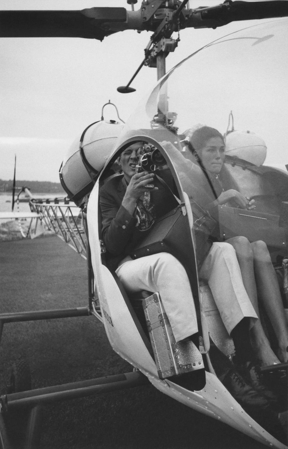 Newlyweds Peter Beard, holding a camera, and Mary Beard (aka Mary Cushing) in a helicopter