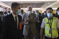 Former Malaysian Prime Minister Najib Razak, center, arrives at the Kuala Lumpur High Court complex in Kuala Lumpur, Malaysia, Tuesday, July 28, 2020. Najib was convicted Tuesday of crimes involving the multibillion-dollar looting of a Malaysian state investment fund that brought down his government in a shocking election ouster two years ago.(Fazry Ismail/Pool Photo via AP)