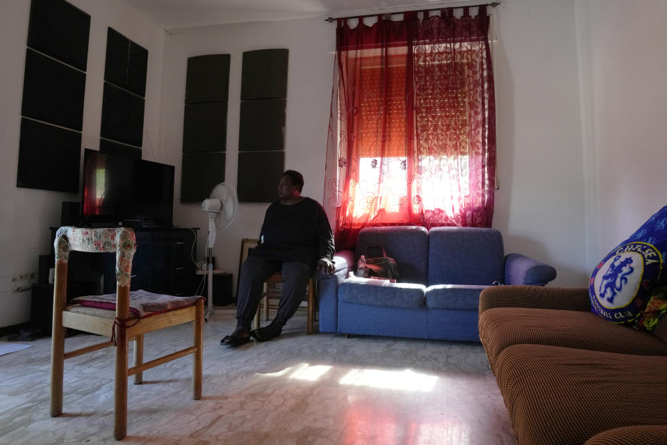 Charity Oriakhi, widow of a street vendor Alika Ogochukwu, sits at her home at the end of an interview with Associated Press, in San Severino Marche, Italy, Friday, Aug. 5, 2022. The brutal killing of a Nigerian immigrant in broad daylight has sparked a debate in this well-to-do Adriatic beach community over whether the attack by an Italian man with a court-documented history of mental illness was racially motivated. It will go to the streets on Saturday, Aug. 6 when a Black Italian activists from all over Italy march through the town demanding justice for Alika Ogorchukwu. (AP Photo/Antonio Calanni)