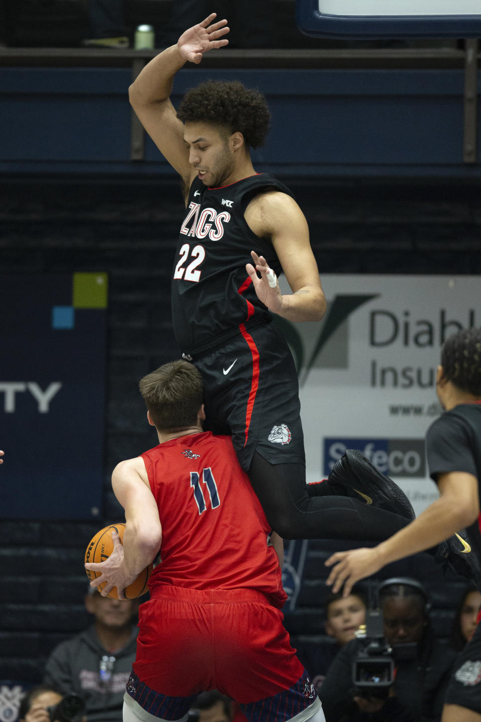 Saint Mary's center Mitchell Saxen (11) ducks under Gonzaga forward Anton Watson (22) during the first half of an NCAA college basketball game, Saturday, Feb. 4, 2023, in Moraga, Calif. (AP Photo/D. Ross Cameron)