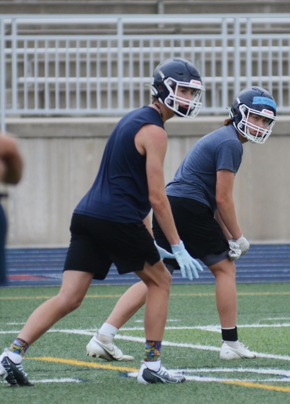 Petoskey wideouts Seth Marek (right) and Brian Pike wait on the snap during a play Monday.