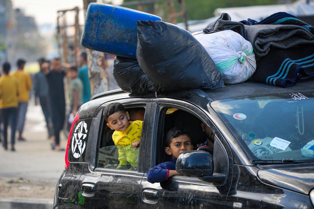 Displaced children look out of car windows as their family flees from Rafah, in the southern Gaza Strip, to safer areas on May 7, 2024, following an evacuation order by the Israeli army amid the ongoing conflict between Israel and the Palestinian Hamas movement.