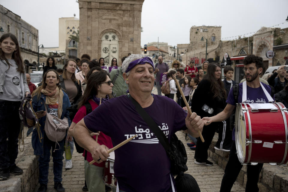 Activists from the Standing Together Movement play drums at a demonstration by left-wing Israelis in solidarity with Palestinians as part of ongoing protests against plans by Israeli Prime Minister Benjamin Netanyahu's government to overhaul the judicial system, in Jaffa, Israel, Thursday, March 23, 2023. Israel’s Palestinian minority has mostly sat out large protests against the government’s plan to overhaul the judiciary, a glaring absence in a battle to preserve Israel’s democratic ideals. The community may have the most to lose from the legal changes. (AP Photo/Maya Alleruzzo)