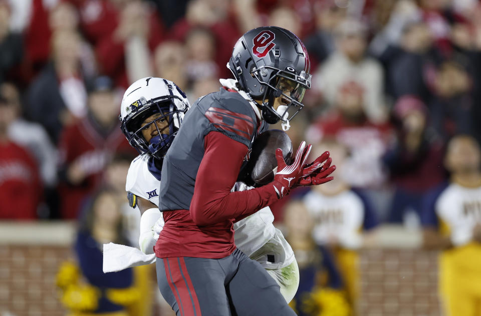 Oklahoma wide receiver Jayden Gibson, right, makes a catch for a touchdown against West Virginia during the first half of an NCAA college football game Saturday, Nov. 11, 2023, in Norman, Okla. (AP Photo/Alonzo Adams)