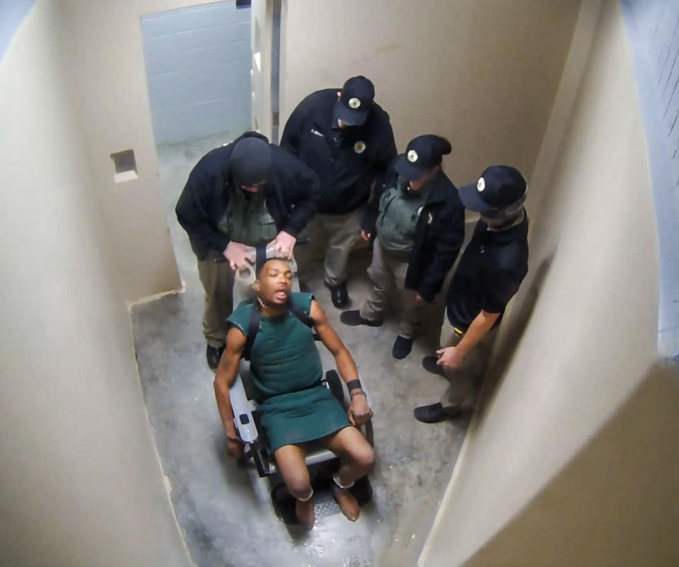 Tremar Harris is choked by a guard while restrained (U.S. District Court)