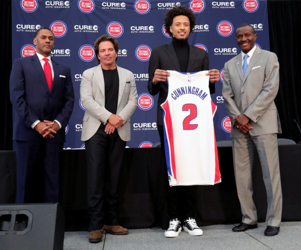 Pistons GM Troy Weaver, owner Tom Gores, first-round pick Cade Cunningham and head coach Dwane Casey pose after the news conference on Friday, July 30, 2021, at the team's practice facility in Detroit.