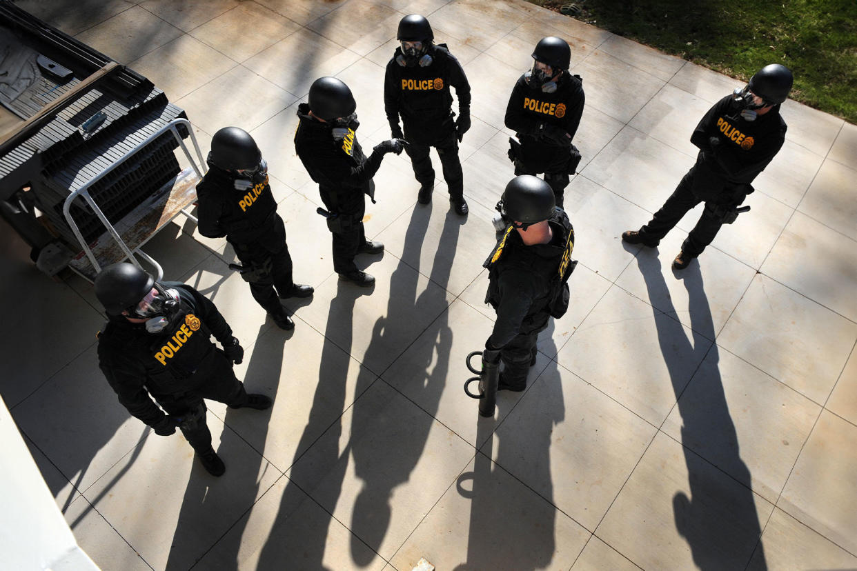 DEA Agents simulate a raid TIM SLOAN/AFP via Getty Images
