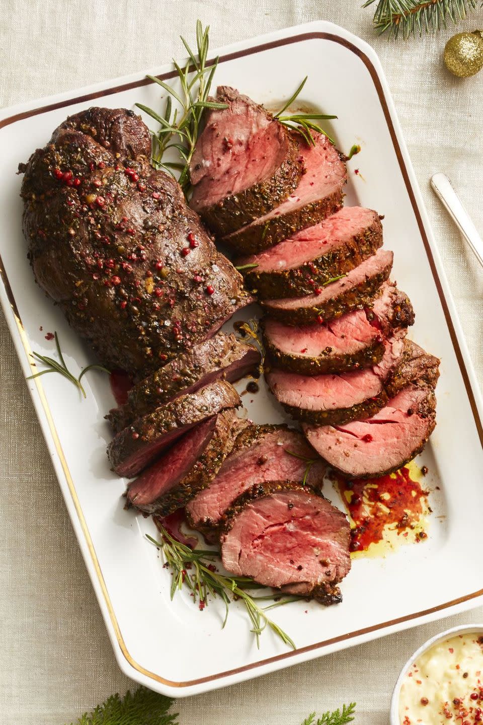 <p>Pink, green, and black peppercorns lend serious spice and pretty pops of color to make this the perfect centerpiece for your Christmas dinner table. </p><p><em><a href="https://www.goodhousekeeping.com/food-recipes/a25324099/peppercorn-beef-tenderloin-recipe/" rel="nofollow noopener" target="_blank" data-ylk="slk:Get the recipe »" class="link rapid-noclick-resp">Get the recipe »</a></em></p>