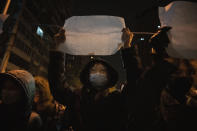 A protestor holds up a blank paper and chant slogans during a march in protest in Beijing, Sunday, Nov. 27, 2022. Protesters angered by strict anti-virus measures called for China's powerful leader to resign, an unprecedented rebuke as authorities in at least eight cities struggled to suppress demonstrations Sunday that represent a rare direct challenge to the ruling Communist Party. (AP Photo/Ng Han Guan)