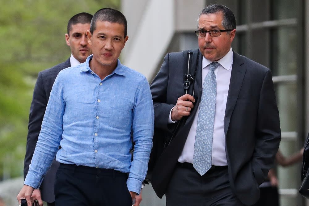 Ex-Goldman Sachs banker Roger Ng (left) and his lawyer Marc Agnifilo leave the federal court in New York May 6, 2019. — Reuters pic