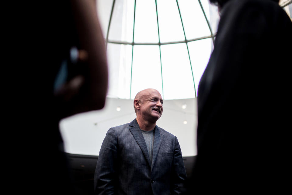 Image: Mark Kelly speaks with guests at a summit in Atlanta in 2014. (Branden Camp / AP file)