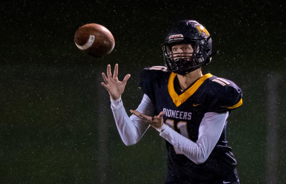 Mooresville High School junior Wes Reeves (11) makes a pass reception during the second half of an IHSAA class 4A sectional football game, Friday, Oct. 29, 2021, at Mooresville High School. East Central High School won, 52-26.