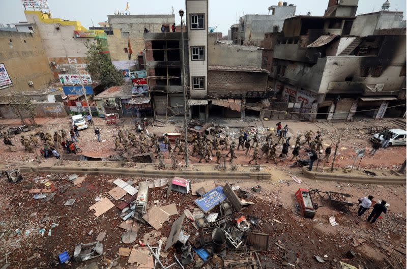 Security forces patrol in a riot affected area following clashes between people demonstrating for and against a new citizenship law in New Delhi