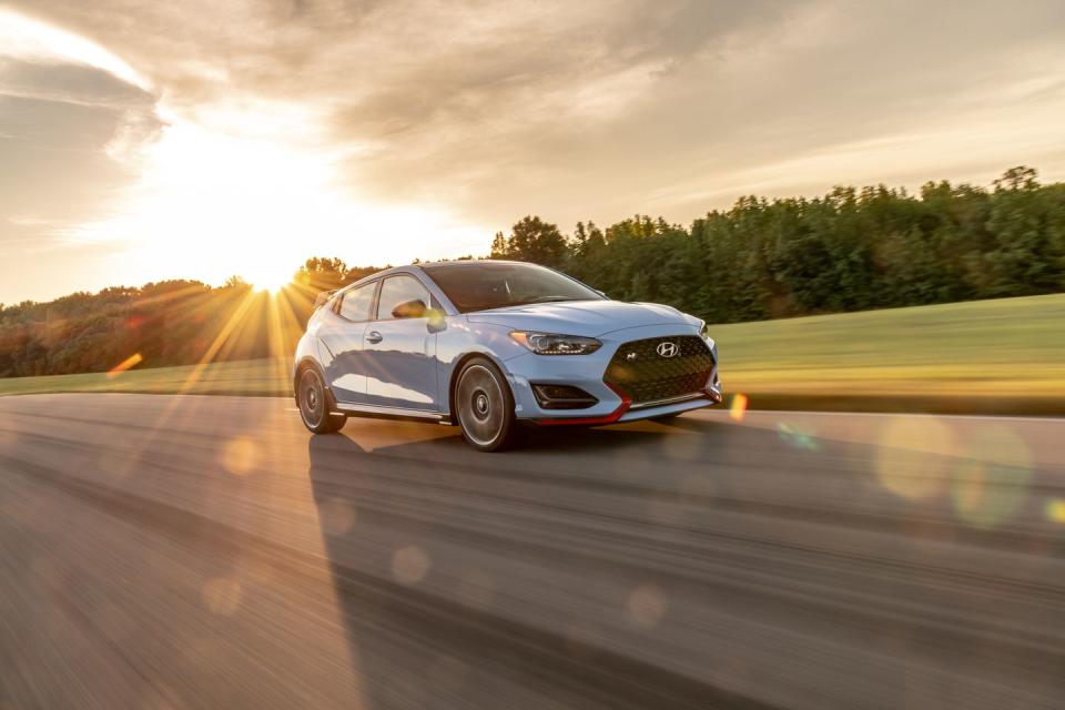 <p>The cheapest way we've ever lapped VIR in under 3:08 is behind the wheel of <a href="https://www.caranddriver.com/hyundai/veloster-n" rel="nofollow noopener" target="_blank" data-ylk="slk:Hyundai's Veloster N;elm:context_link;itc:0;sec:content-canvas" class="link ">Hyundai's Veloster N</a>. Its 275-hp turbocharged inline-four pulls like a team of pissed-off wild horses. Shifting through gears is snappy thanks to its stable feeling gates, which makes upshifts met by quick rev-matched downshifts a breeze that require less footwork. The electronically-controlled limited-slip differential puts the torque down precisely when it's needed which <a href="https://www.caranddriver.com/features/a29389240/2019-hyundai-veloster-n-lightning-lap/" rel="nofollow noopener" target="_blank" data-ylk="slk:helped it maintain high speeds in corners;elm:context_link;itc:0;sec:content-canvas" class="link ">helped it maintain high speeds in corners</a>. Although its 64/36 weight distribution keeps the Veloster N's nose down, regardless of how hard the front wheels might sniff, understeer doesn't become a problem. </p>