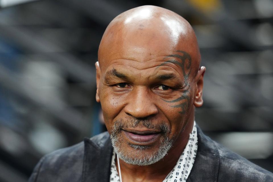 Mike Tyson poses for a photo on the sidelines before the start of a game between the Las Vegas Raiders and the Pittsburgh Steelers at Allegiant Stadium in 2023.