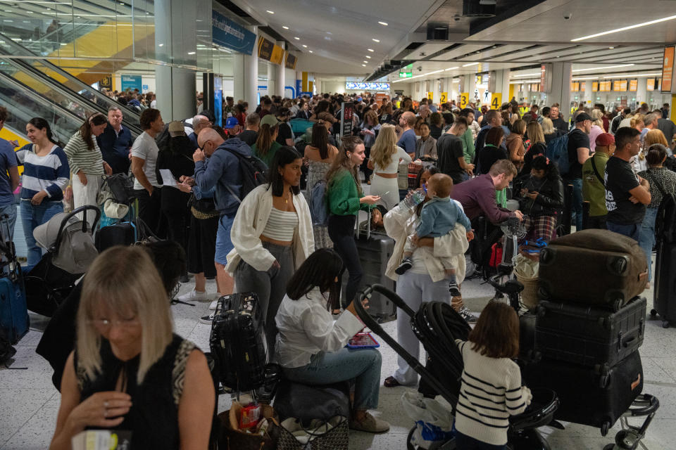 CRAWLEY, ENGLAND - AUGUST 28: People wait near check-in desks at Gatwick Airport on August 28, 2023 in Crawley, United Kingdom. The United Kingdom's air traffic control systems have grounded thousands of flights on one of the busiest travel days of the year. All flights to and from the UK are reported to be affected and delays could last for days. (Photo by Carl Court/Getty Images)