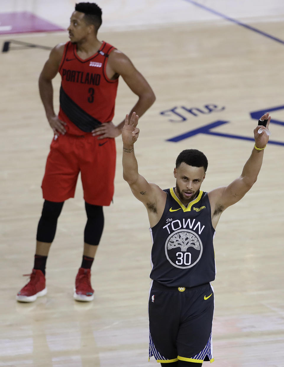 Golden State Warriors guard Stephen Curry (30) celebrates in front of Portland Trail Blazers guard CJ McCollum (3) during the second half of Game 2 of the NBA basketball playoffs Western Conference finals in Oakland, Calif., Thursday, May 16, 2019. (AP Photo/Ben Margot)