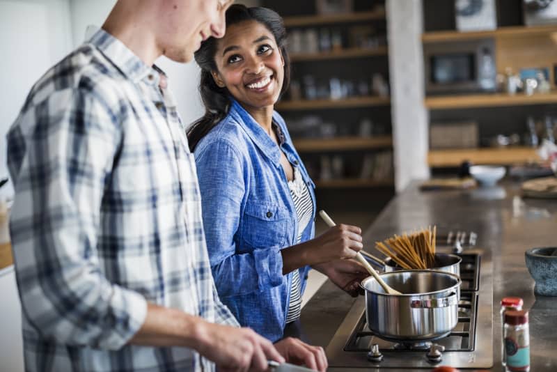 Couple cooking together in kitchen