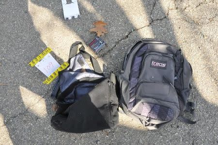 A 9mm Luger clip and bullet package sit next to a backpack and bag on a street where Tamerlan and Dzhokhar Tsarnaev engaged in a gunfight with police in this undated handout evidence photo provided by the U.S. Attorney's Office in Boston, Massachusetts on March 24, 2015. REUTERS/U.S. Attorney's Office/Handout.