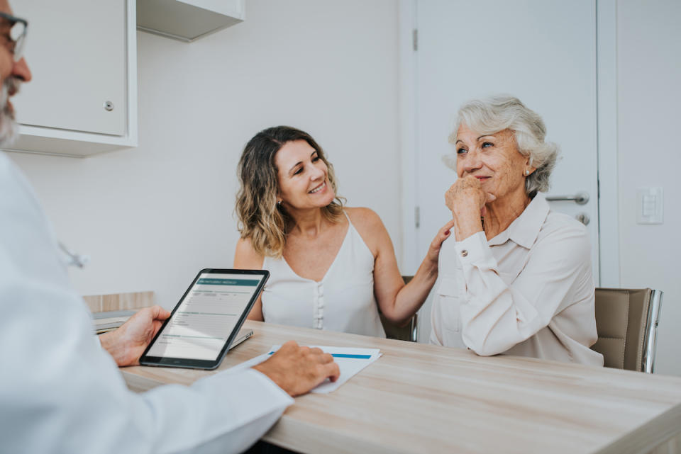 Woman with her adult daughter at doctor's appointment patronizing