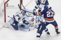 Tampa Bay Lightning goalie Andrei Vasilevskiy (88) makes a save on New York Islanders' Anders Lee (27) as Kevin Shattenkirk (22) defends during the second period of Game 3 of the NHL hockey Eastern Conference final, Friday, Sept. 11, 2020, in Edmonton, Alberta. (Jason Franson/The Canadian Press via AP)
