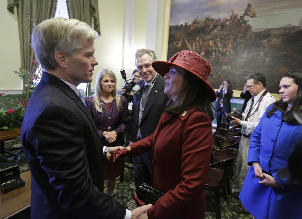 Outgoing Virginia Gov. Bob McDonnell, left, talks with Dorothy McAuliffe, right, as Gov-elect, Terry McAuliffe, second from right and Maureen McDonnell look on prior to the inauguration of Virginia Governor Terry McAuliffe on the steps of the South Portico of the Capitol in Richmond, Va., Saturday, Jan. 11, 2014. McAuliffe was inaugurated as the 72nd Governor of Virginia. (AP Photo/Steve Helber)