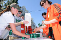 HOPKINTON, MA - APRIL 16: Volunteers prepare cups of water for runners at the start of the 116th running of the Boston Marathon April 16, 2012 in Hopkinton, Massachusetts. (Photo by Darren McCollester/Getty Images)