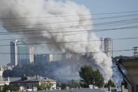 Smoke rises from a pyrotechnics warehouse in Moscow, Russia, Saturday, June 19, 2021. A large fire broke out at a fireworks depot in the center of Moscow. The fire is raging at the area of 500 square meters, Russia emergency services said in the statement. (AP Photo/Pavel Golovkin)