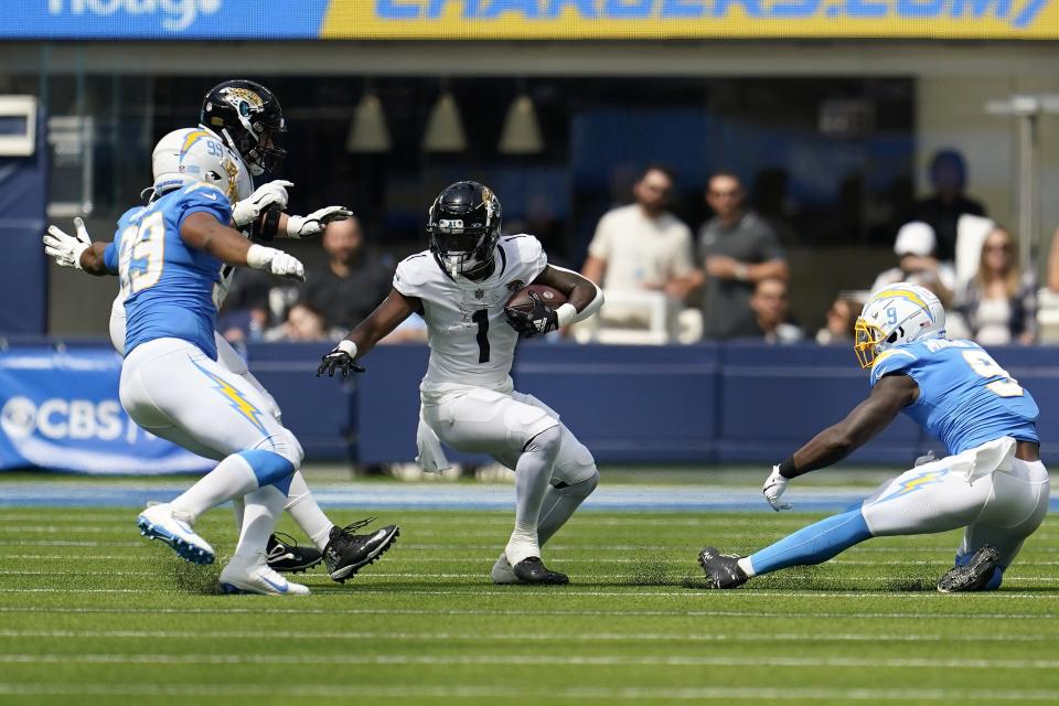 Jacksonville Jaguars running back Travis Etienne Jr. (1) runs against the Los Angeles Chargers during the first half of an NFL football game in Inglewood, Calif., Sunday, Sept. 25, 2022. (AP Photo/Marcio Jose Sanchez)