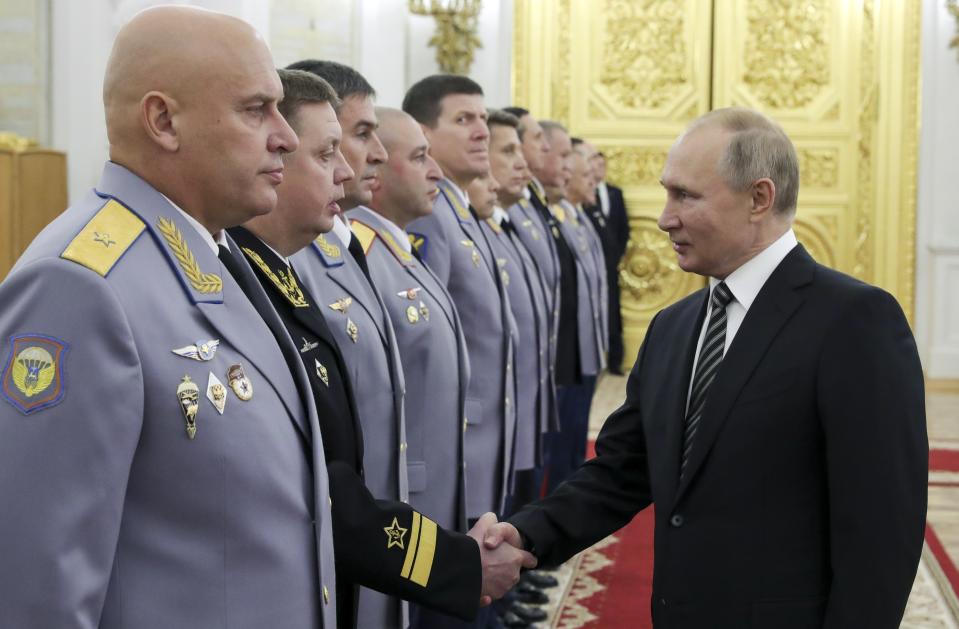 Russian President Vladimir Putin greets senior military officers during a meeting in Moscow, Russia, Wednesday, Nov. 6, 2019. Putin said Russia's new weapons have no foreign equivalents but he insists the country will not use them to threaten anyone. (Mikhail Klimentyev, Sputnik, Kremlin Pool Photo via AP)