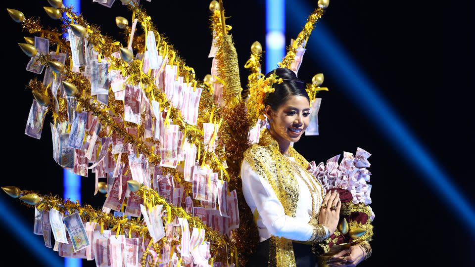Miss Myanmar's national costume took inspiration from a tradition in Buddhist communities in which a portion of a family or individual's savings are donated to their local monastery. - Hector Vivas/Getty Images