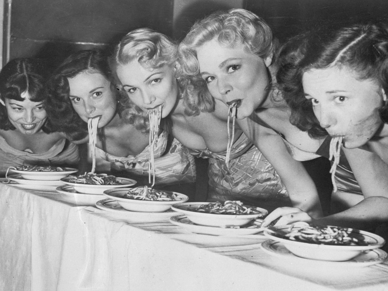 Women eating spaghetti competition
