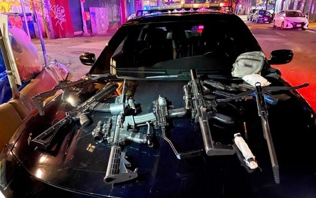 Police found a cache of weapons in a nearby building including crossbows, replica assault rifles, scopes, lights and lasers, after a man was shot with an arrow in Vancouver's Downtown Eastside. (Vancouver Police Department - image credit)