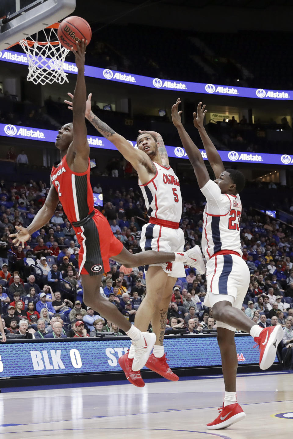 Georgia guard Jordan Harris (2) drives past Mississippi defenders KJ Buffen (5) and Sammy Hunter (23) in the first half of an NCAA college basketball game in the Southeastern Conference Tournament Wednesday, March 11, 2020, in Nashville, Tenn. (AP Photo/Mark Humphrey)