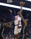 New York Knicks' Julius Randle (30) shoots between Golden State Warriors' Draymond Green, left, and Alec Burks in the first half of an NBA basketball game, Wednesday, Dec. 11, 2019, in San Francisco. (AP Photo/Ben Margot)