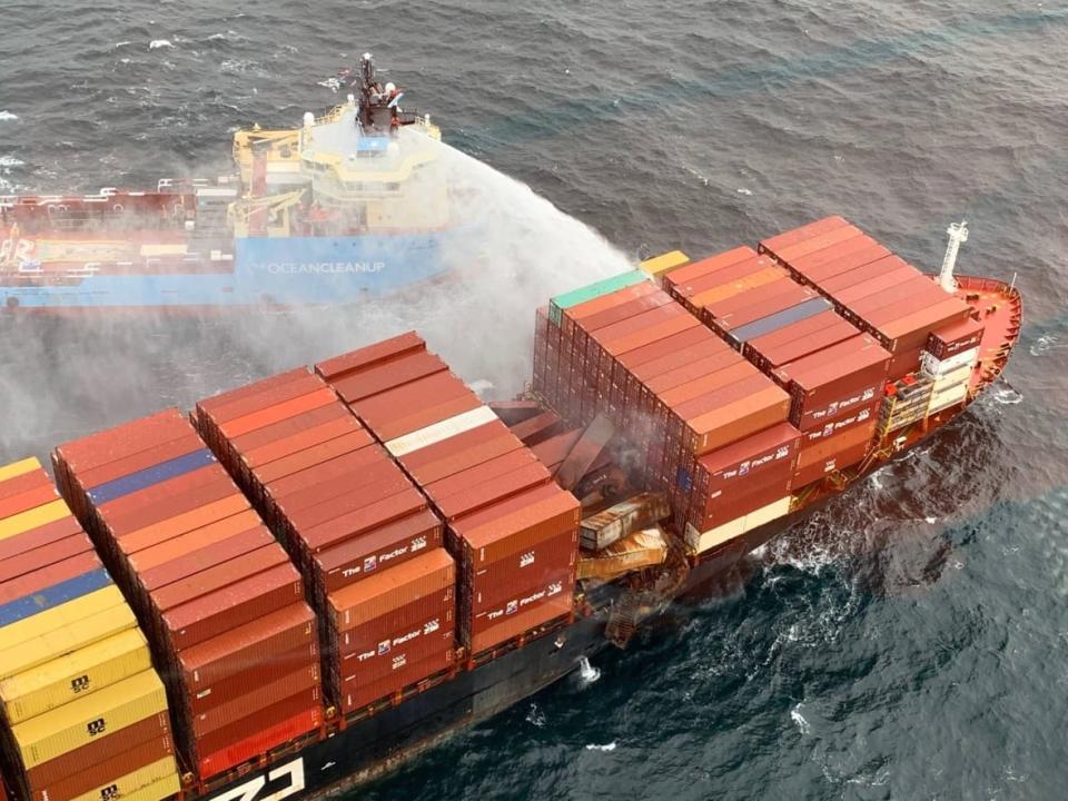 A cleanup vessel responds to the fire onboard the MV Zim Kingston on Monday.  (Canadian Coast Guard/Twitter - image credit)