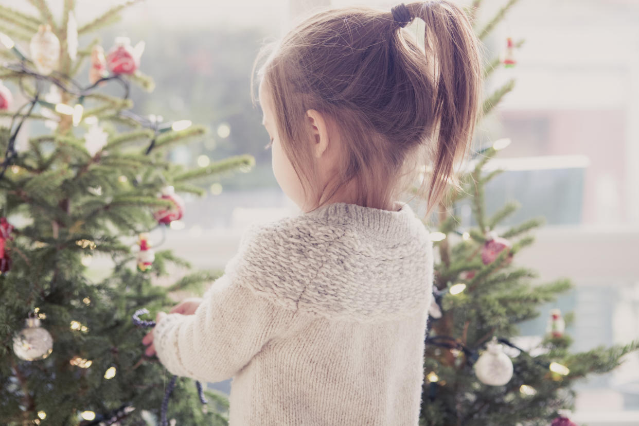 Girl decorating Christmas tree