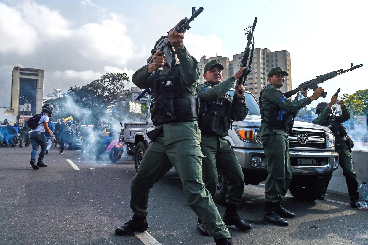 Members of the Bolivarian National Guard who joined Venezuelan opposition leader and self-proclaimed acting president Juan Guaido fire into the air to repel forces loyal to President Nicolas Maduro who arrived to disperse a demonstration near La Carlota military base in Caracas on April 30, 2019. (Photo: Federico Parra/AFP/Getty Images)