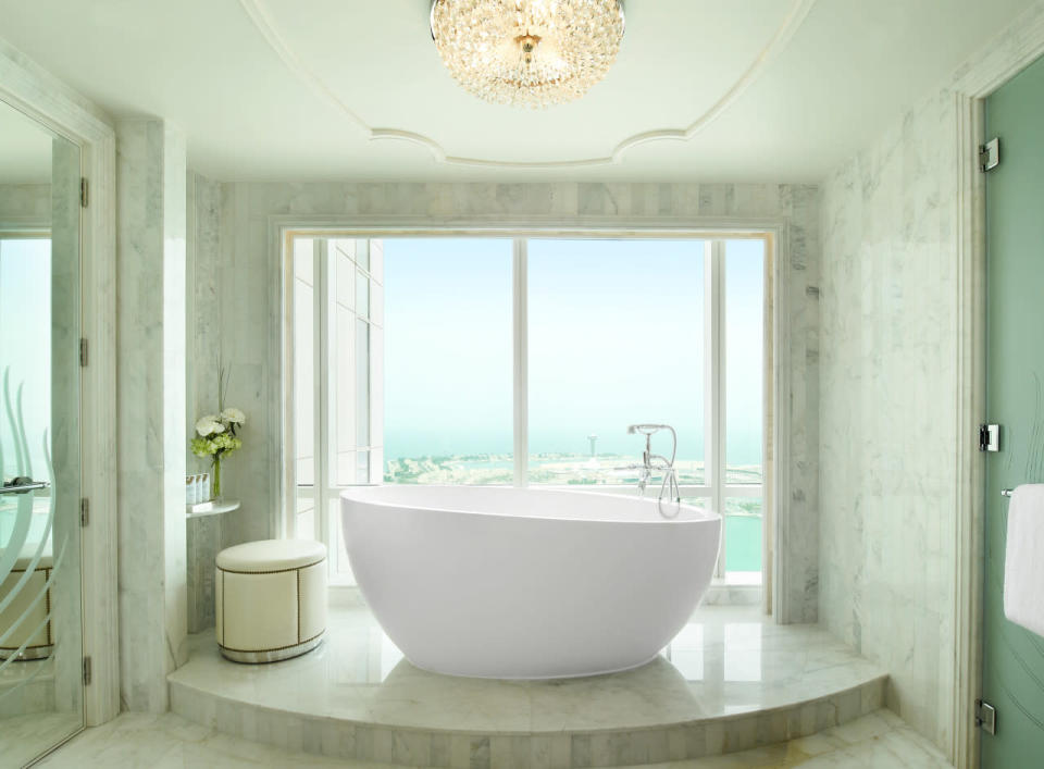 <p>With floor-to-ceiling marble, amazing views, and one of the biggest tubs we’ve ever seen it’s hard to imagine a more glamorous bathroom. (Photo: St. Regis)</p>