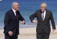 British Prime Minister Boris Johnson, right, greets Australia's Prime Minister Scott Morrison during arrivals for the G7 meeting at the Carbis Bay Hotel in Carbis Bay, St. Ives, Cornwall, England, Saturday, June 12, 2021. Leaders of the G7 gather for a second day of meetings on Saturday, in which they will discuss COVID-19, climate, foreign policy and the economy. (AP Photo/Kirsty Wigglesworth, Pool)