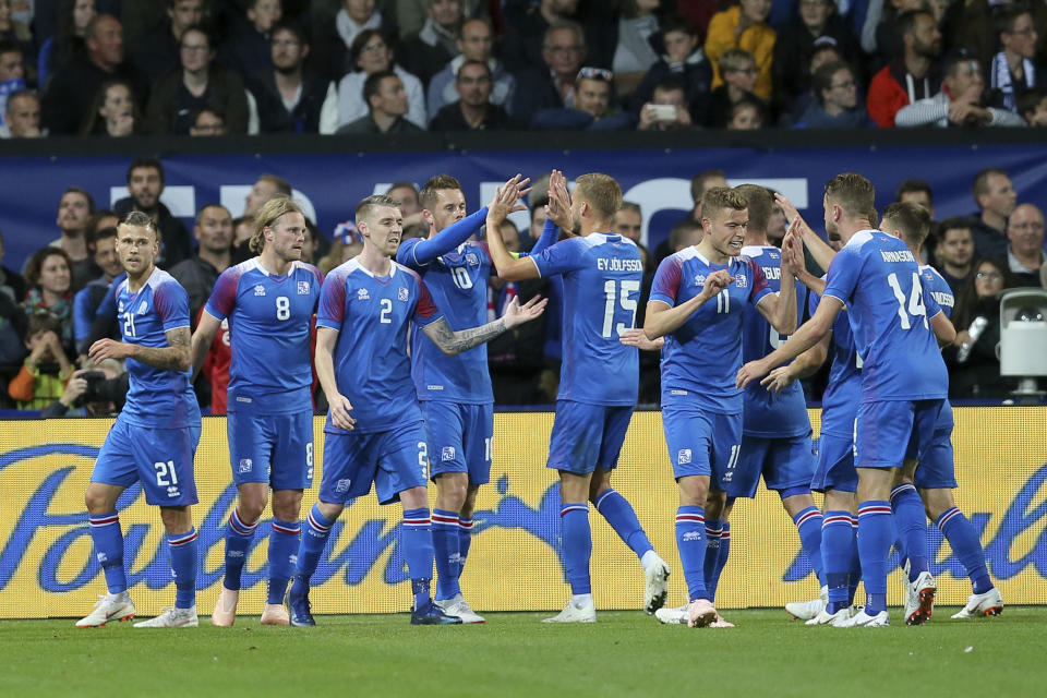 Iceland's players celebrate after Iceland's Birkir Bjarnason, second from left, scored a goal during a friendly soccer match between France and Iceland, in Guingamp, western France, Thursday, Oct. 11, 2018. (AP Photo/David Vincent)