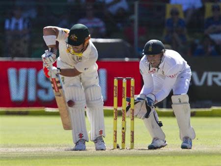 Australia's Dave Warner is trapped leg before wicket as South Africa's AB de Villiers looks on during the fourth day of the second cricket test match in Port Elizabeth, February 23, 2014. REUTERS/Rogan Ward