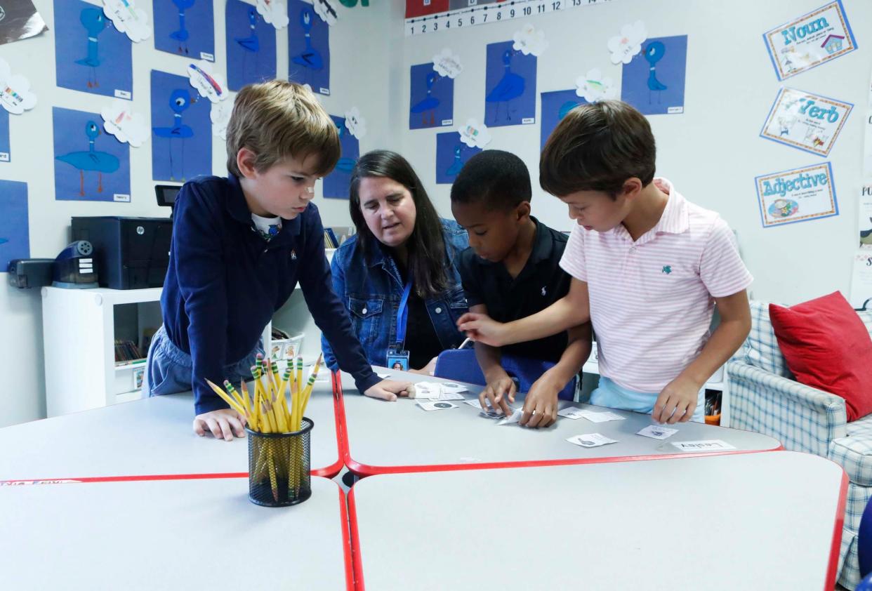 Teacher Ginny Brundick works with students during class at Presbyterian Day School, located at 4025 Poplar Ave. in Memphis, on Nov. 9, 2023.