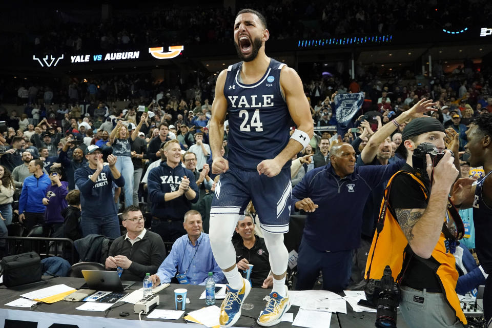 Yale guard Yassine Gharram celebrates with fans after Yale upset Auburn in a first-round NCAA tournament game in Spokane, Wash., Friday, March 22, 2024. (AP Photo/Ted S. Warren)