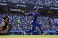 Los Angeles Dodgers' Trea Turner, right, hits a solo home run as San Francisco Giants catcher Joey Bart watches during the third inning of a baseball game Saturday, July 23, 2022, in Los Angeles. (AP Photo/Mark J. Terrill)